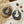 Load image into Gallery viewer, Silver hoop earrings on a textured surface with small stones and pebbles.
