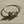 Load image into Gallery viewer, Gold bracelet with heart-shaped charms on a light beige surface
