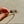 Load image into Gallery viewer, Gold bracelet with cat-shaped charms held by a hand on a beige surface
