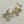 Load image into Gallery viewer, Pair of gold and crystal teardrop earrings on a light gray background
