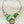 Load image into Gallery viewer, Necklace with green and silver design on a dark surface
