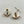 Load image into Gallery viewer, Pair of gold and crystal earrings on a light gray background
