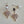 Load image into Gallery viewer, Pair of earrings with pearl and crystal details on a light gray background
