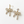 Load image into Gallery viewer, Gold bow-shaped earrings with clear stones on a white background
