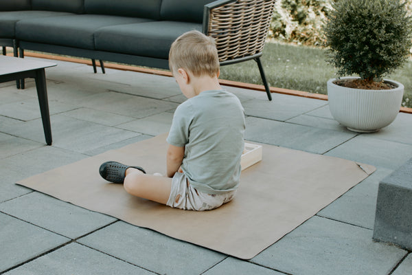Uniklook hunter green and tan med vegan leather mat used outside as a picnic mat