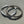 Load image into Gallery viewer, Two silver hoop earrings on a textured gray surface
