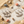 Load image into Gallery viewer, Silver earrings on a marble surface with seashells and sand around

