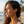Load image into Gallery viewer, Woman with curly hair and earrings on a beach
