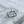 Load image into Gallery viewer, Silver geometric ring on a textured wooden surface
