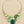 Load image into Gallery viewer, Necklace with green and silver design on a dark surface
