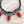 Load image into Gallery viewer, Colorful necklace with gemstones on a dark surface

