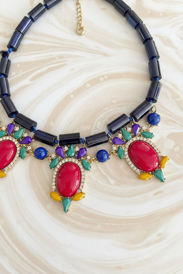 Colorful necklace with gemstones on a dark surface
