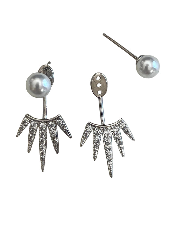 Silver earrings with pearl and gemstone details on a light gray background