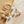Load image into Gallery viewer, Set of pearl and gold earrings on a marble surface with sand.
