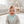Load image into Gallery viewer, Baby wearing a green and white striped bib in a bright room.
