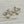 Load image into Gallery viewer, Gold earrings with clear gemstones on a light gray background
