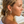 Load image into Gallery viewer, Woman with braided hair and hoop earrings on a beach
