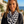 Load image into Gallery viewer, Woman wearing a black and white striped scarf with a scenic background
