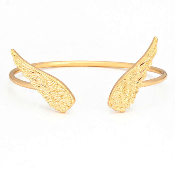 Gold wing-shaped bracelet on a white background