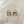 Load image into Gallery viewer, Pair of gold earrings on a light wooden surface
