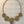 Load image into Gallery viewer, Gold spiral necklace on a dark marble surface

