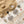 Load image into Gallery viewer, Silver earrings with pearls on a textured surface resembling sand and stone.
