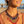 Load image into Gallery viewer, Woman wearing a colorful beaded necklace with a blurred beach background
