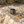 Load image into Gallery viewer, Black cylindrical object on a textured rock surface with sand
