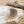 Load image into Gallery viewer, Decorative silver ring on a rock with sand and driftwood in the background
