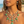 Load image into Gallery viewer, Woman wearing a green and gold necklace on a beach
