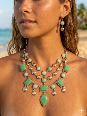 Woman wearing a green and gold necklace on a beach