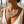 Load image into Gallery viewer, Close-up of a woman wearing a sparkling necklace with a blurred floral background
