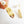 Load image into Gallery viewer, Gold feather-shaped earrings with pearls on a white background

