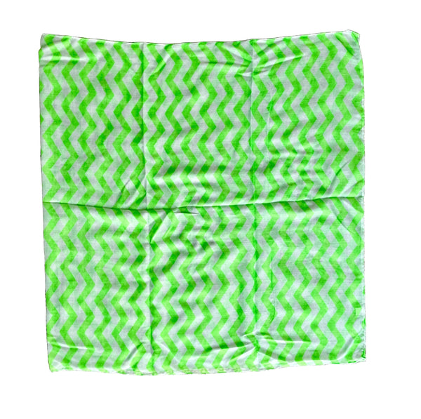 Green and white zigzag patterned fabric on a textured surface