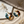 Load image into Gallery viewer, Tortoiseshell hoop earrings on a marble surface with dried flowers.

