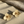 Load image into Gallery viewer, Gold flower-shaped earrings on a textured beige surface
