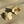 Load image into Gallery viewer, Gold floral and geometric earrings on sand
