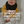 Load image into Gallery viewer, Baby wearing a black knot hat with text about soft signature knot hats.
