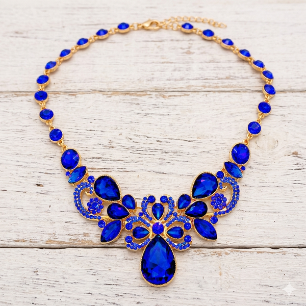 Necklace with blue stones and gold accents on a wooden surface