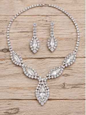 Clear rhinestone necklace and earrings on pale rustic wood