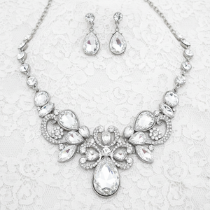 Jewelry set with necklace and earrings featuring teardrop-shaped crystals on a white background