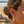 Load image into Gallery viewer, Close-up of a person's ear with earrings on a beach.
