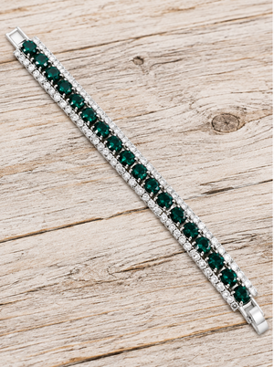 Emerald green crystal tennis bracelet on pale rustic wood