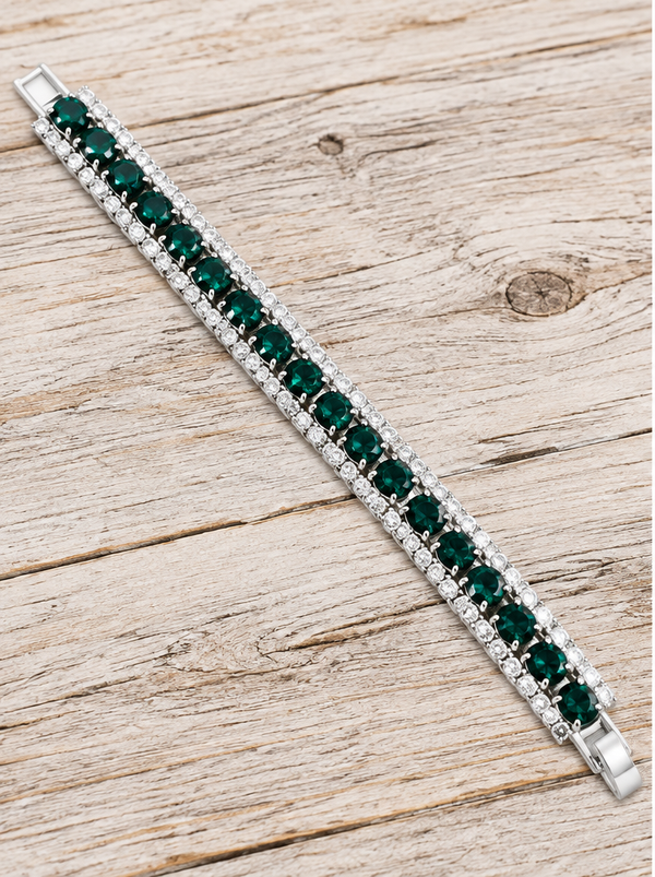 Emerald green crystal tennis bracelet on pale rustic wood