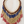 Load image into Gallery viewer, Beaded necklace with red, blue, and gold beads on a light wooden surface

