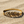 Load image into Gallery viewer, Gold feather bracelet on a sandy surface
