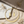 Load image into Gallery viewer, Gold necklace and earrings on a marble surface with dried flowers.
