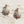 Load image into Gallery viewer, Gold sunburst earrings with clear gemstones on a wooden surface
