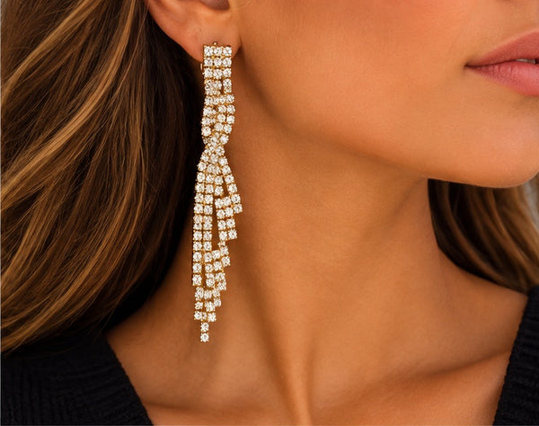 Gold rhinestone cascade earrings worn by model