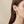 Load image into Gallery viewer, Close-up of a woman wearing a gold earring with three pearl-like stones on a beige background
